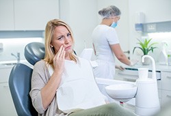 A woman suffering from a toothache at a dental clinic