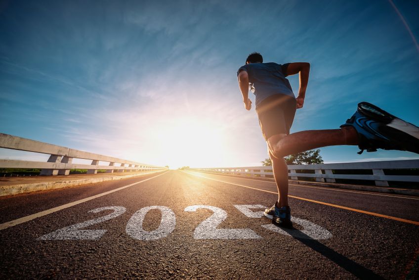 A jogger running past 2025 written on the road